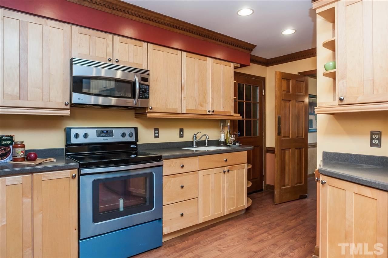 7205 Sawbuck Court Raleigh, NC 27613 - Photo 11 of 25 a kitchen with stainless steel appliances granite countertop a stove a sink and a refrigerator