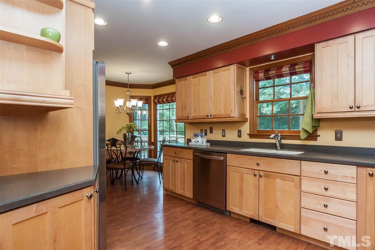 7205 Sawbuck Court Raleigh, NC 27613 - Photo 12 of 25 a kitchen with lots of counter top space and dining table