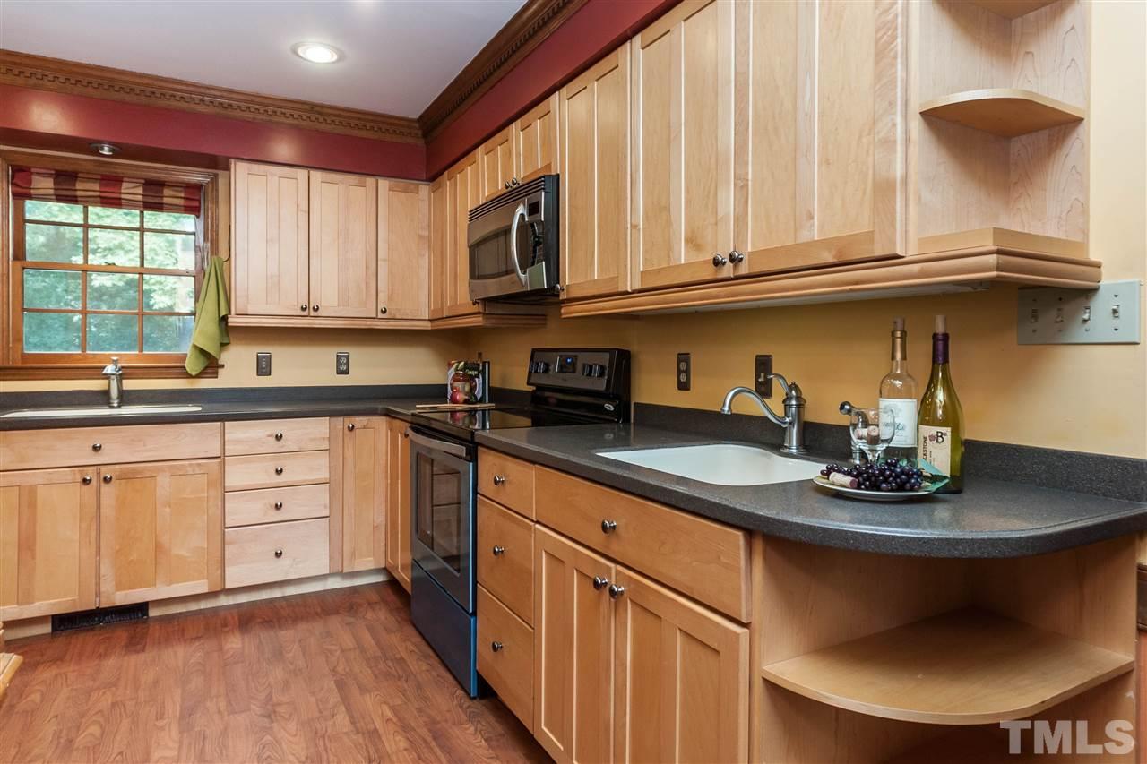 7205 Sawbuck Court Raleigh, NC 27613 - Photo 13 of 25 a kitchen with stainless steel appliances granite countertop a sink a stove and cabinets
