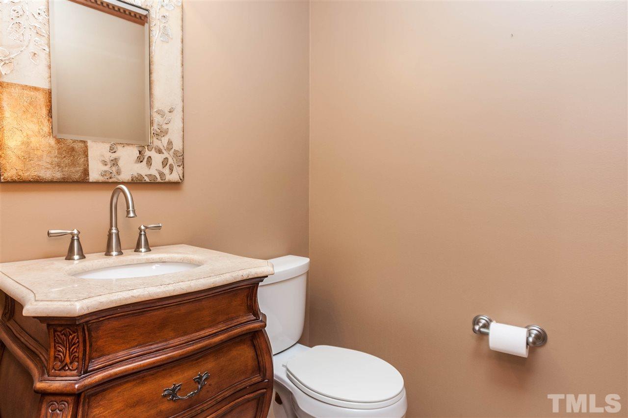 7205 Sawbuck Court Raleigh, NC 27613 - Photo 14 of 25 a bathroom with a sink a toilet and mirror