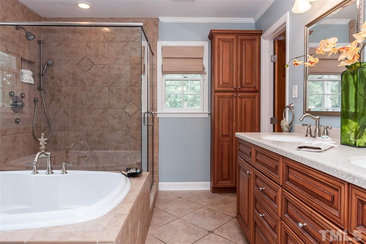 7205 Sawbuck Court Raleigh, NC 27613 - Photo 16 of 25 a bathroom with a bathtub and a sink