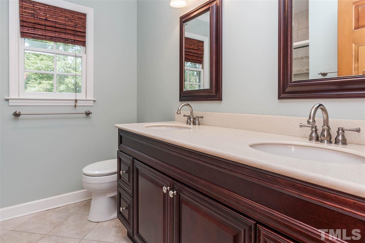 7205 Sawbuck Court Raleigh, NC 27613 - Photo 19 of 25 a bathroom with a sink and a toilet