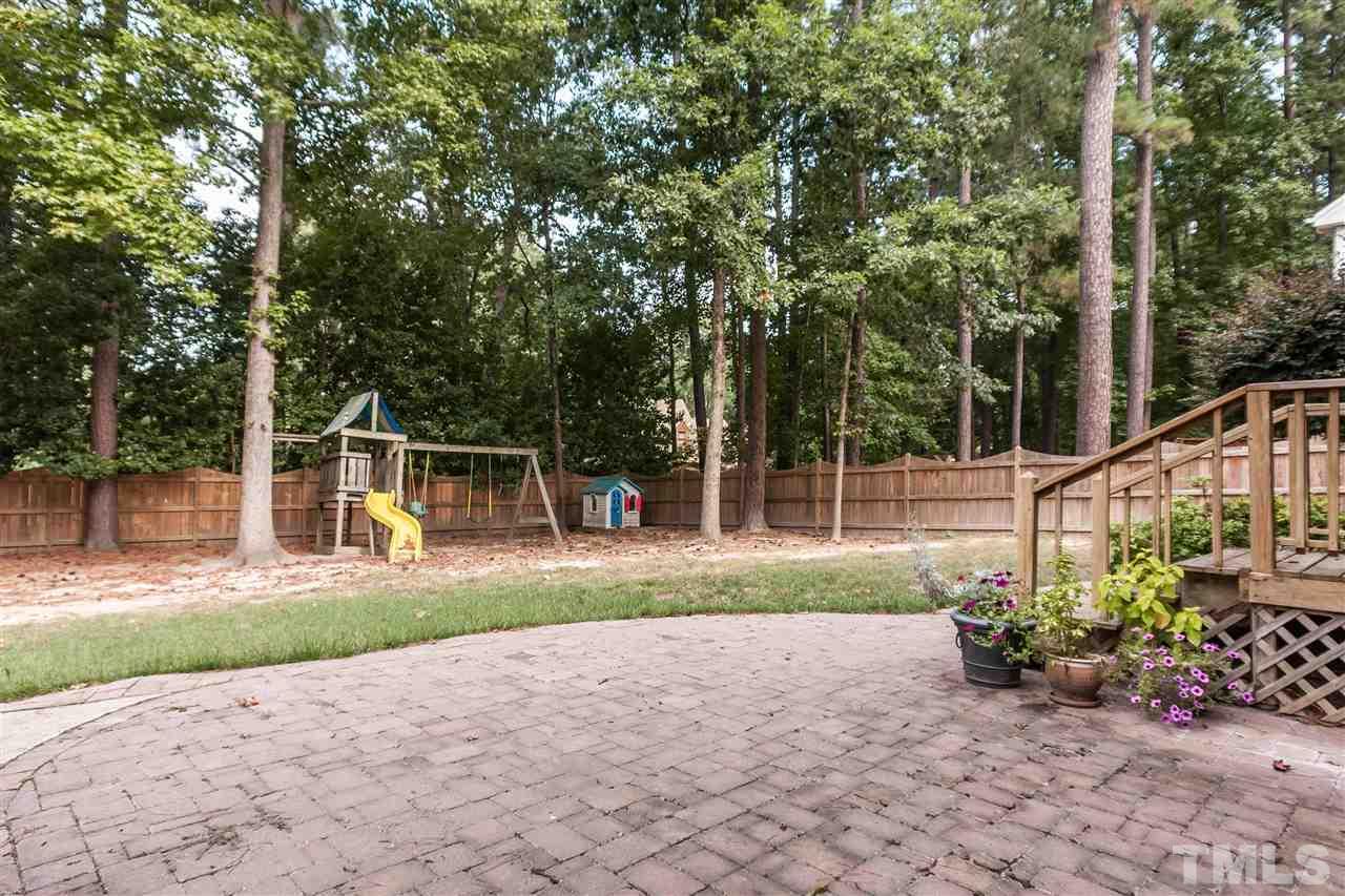7205 Sawbuck Court Raleigh, NC 27613 - Photo 24 of 25 a view of a backyard with plants and a garden