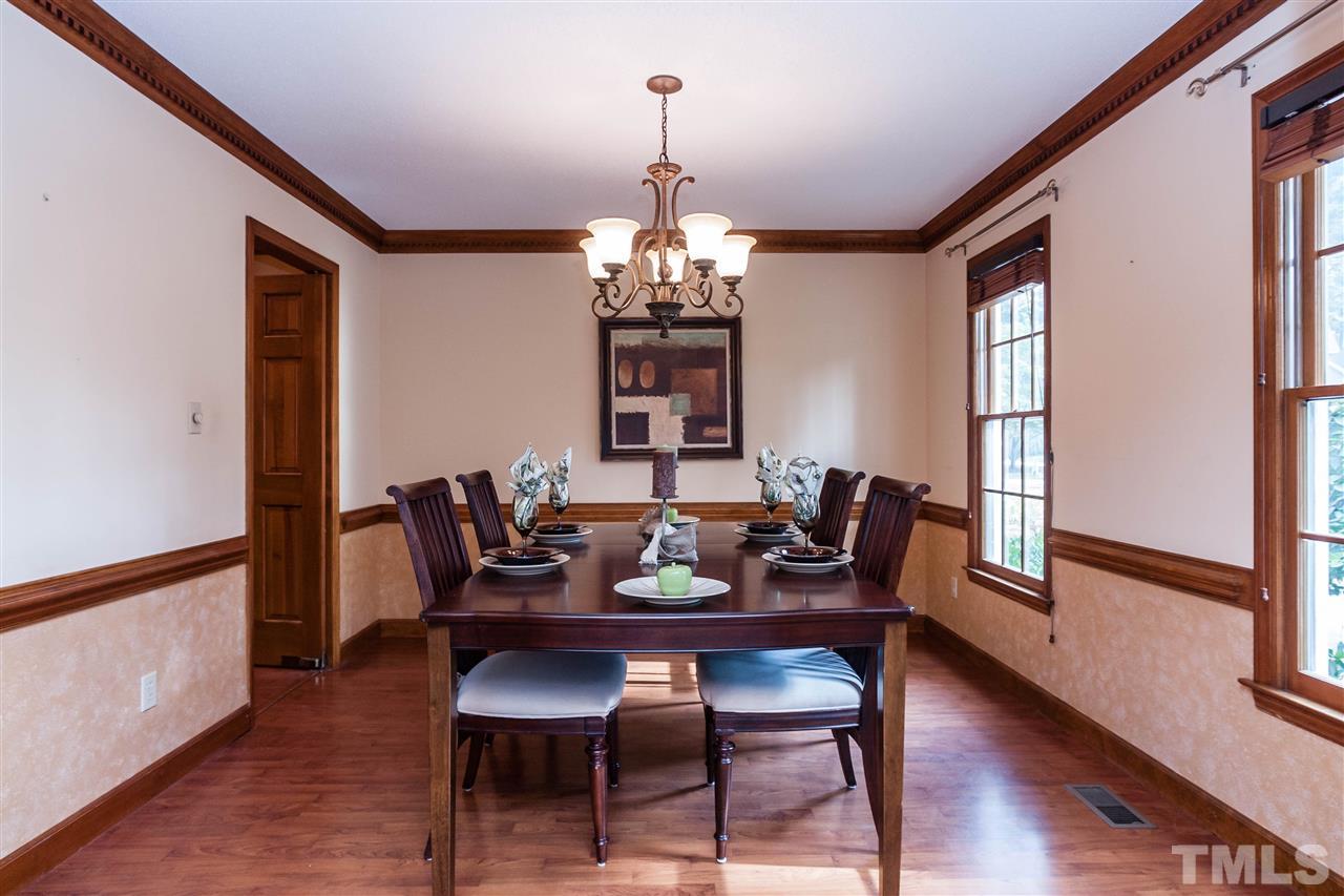 7205 Sawbuck Court Raleigh, NC 27613 - Photo 8 of 25 a view of a dining room with furniture window and wooden floor