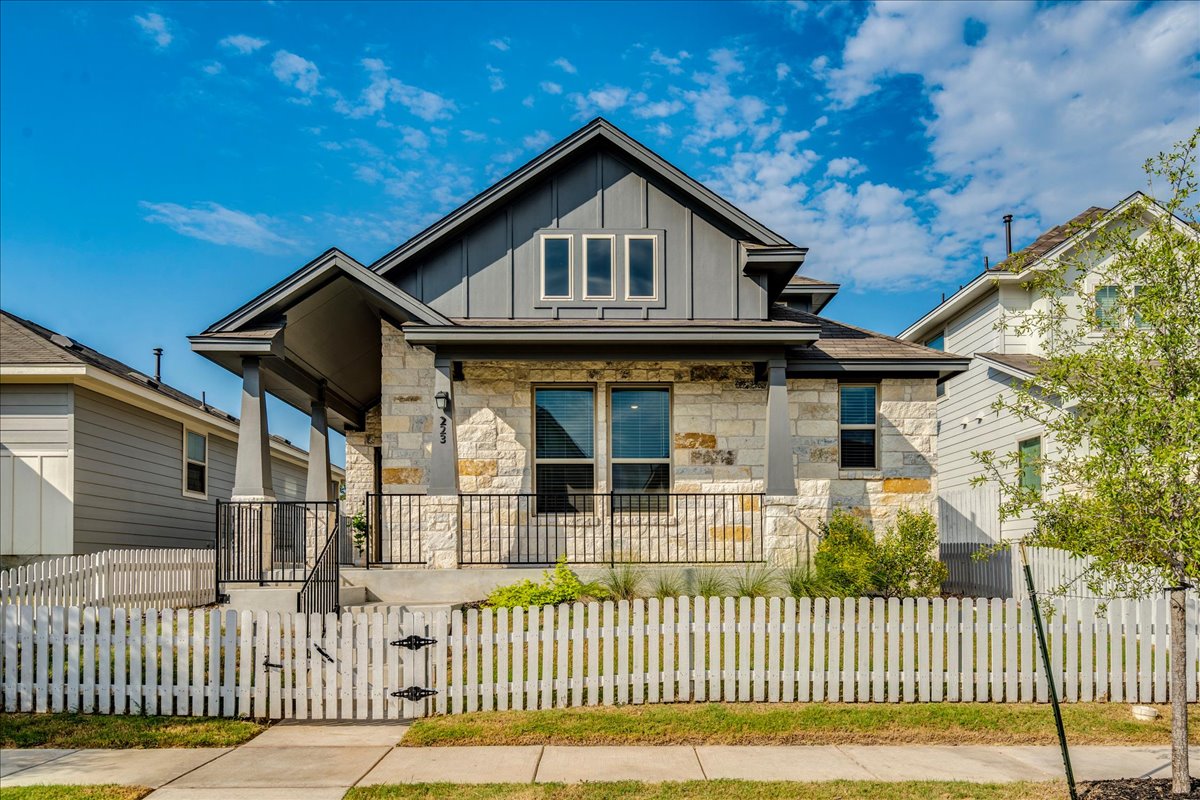 223 Rieber Road Kyle, TX 78640 - Photo 1 of 40 Craftsman details and textured stone masonry define this welcoming home exterior behind a neat fence.