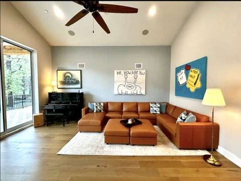 2007 Manana Street Austin, TX 78730 - Photo 20 of 38 Living area featuring lofted ceiling, a ceiling fan, and wood finished floors