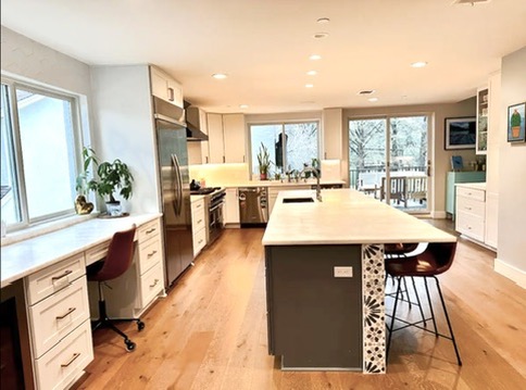 2007 Manana Street Austin, TX 78730 - Photo 35 of 38 Kitchen featuring built in study area, an island with sink, a kitchen breakfast bar, light wood-type flooring, and recessed lighting