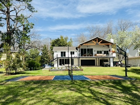 2007 Manana Street Austin, TX 78730 - Photo 36 of 38 View of basketball court with a yard, a balcony, and a patio area