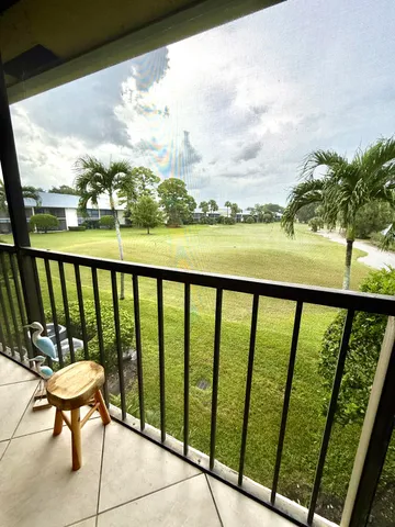 a view of balcony with furniture