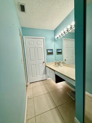 a bathroom with a double vanity sink and mirror