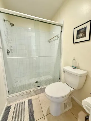 a bathroom with a toilet and a shower