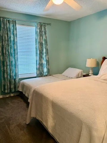 a bed sitting in a bedroom next to a window