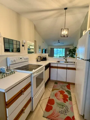 a kitchen with a sink appliances and cabinets