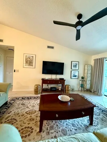 a living room with a flat screen tv and a table