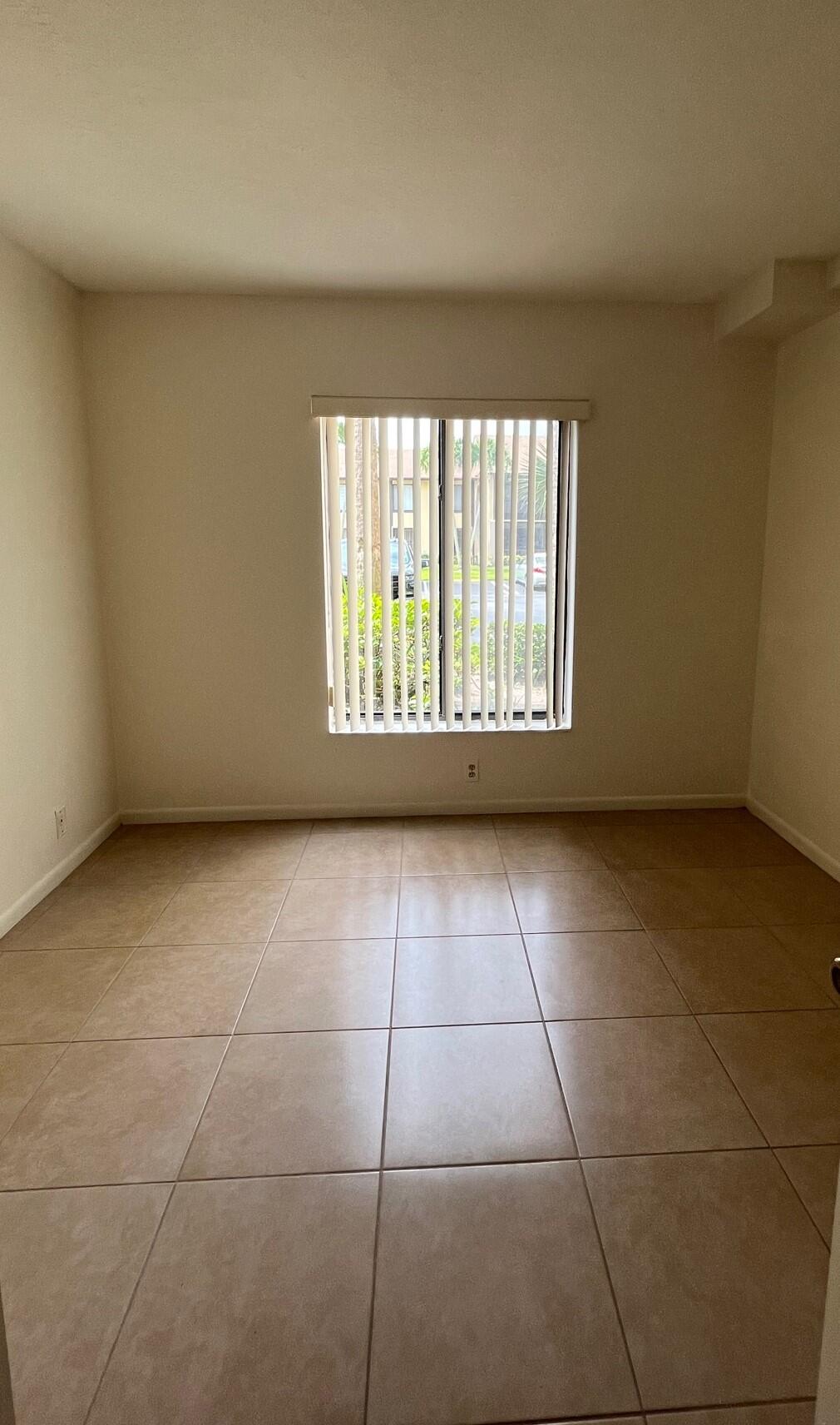 801 Sky Pine Way, Unit B1 Greenacres, FL 33415 - Photo 11 of 17 a view of an empty room with a window