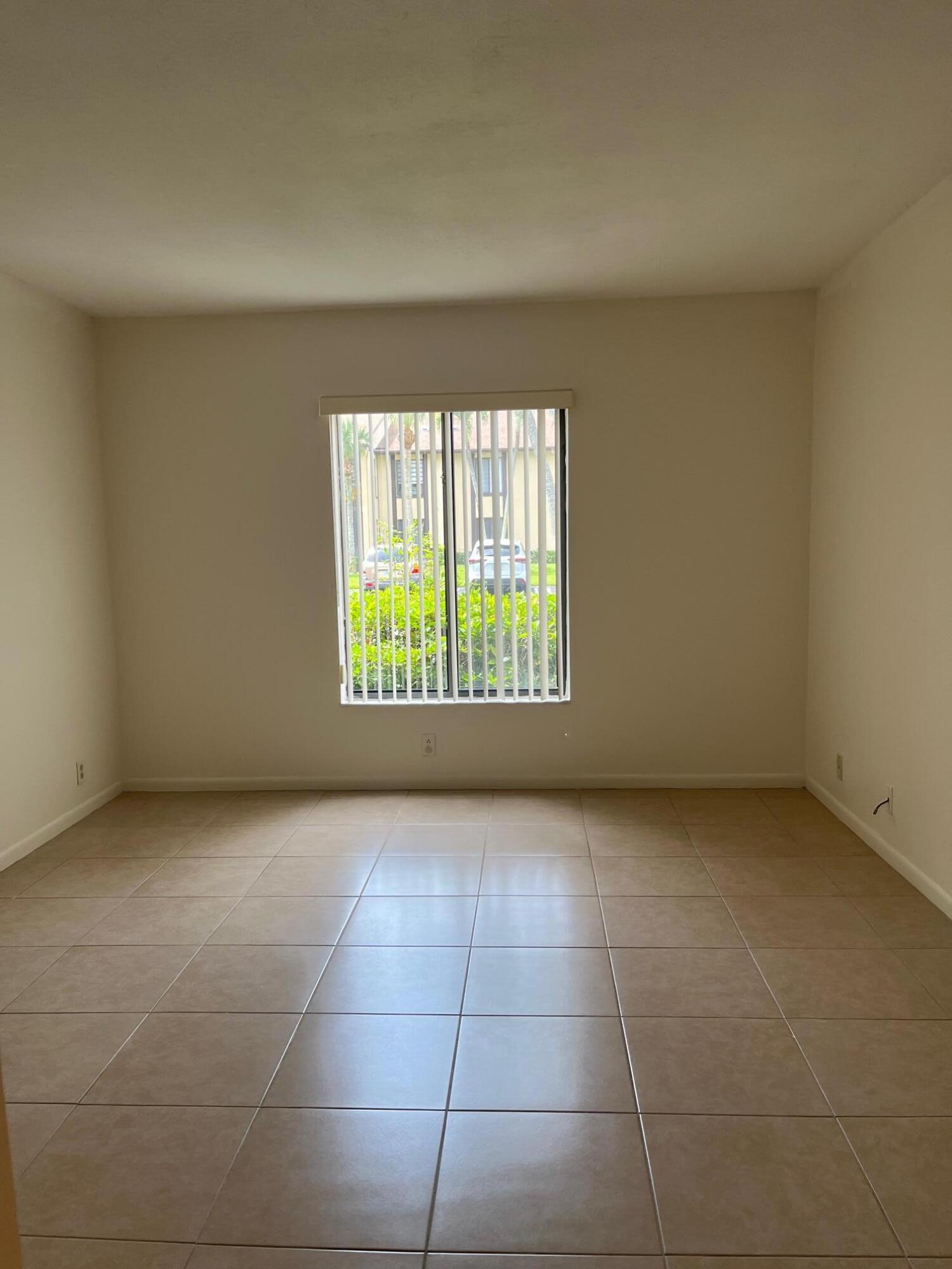 801 Sky Pine Way, Unit B1 Greenacres, FL 33415 - Photo 12 of 17 a view of an empty room with a window
