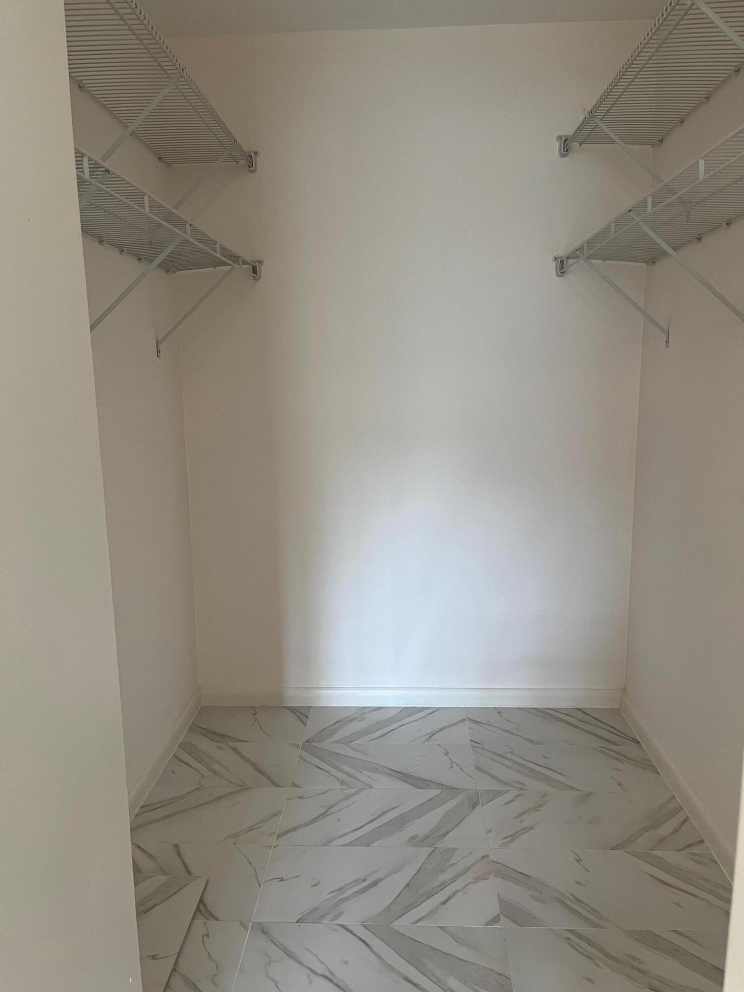 801 Sky Pine Way, Unit B1 Greenacres, FL 33415 - Photo 15 of 17 a view of a room with racks on the wall