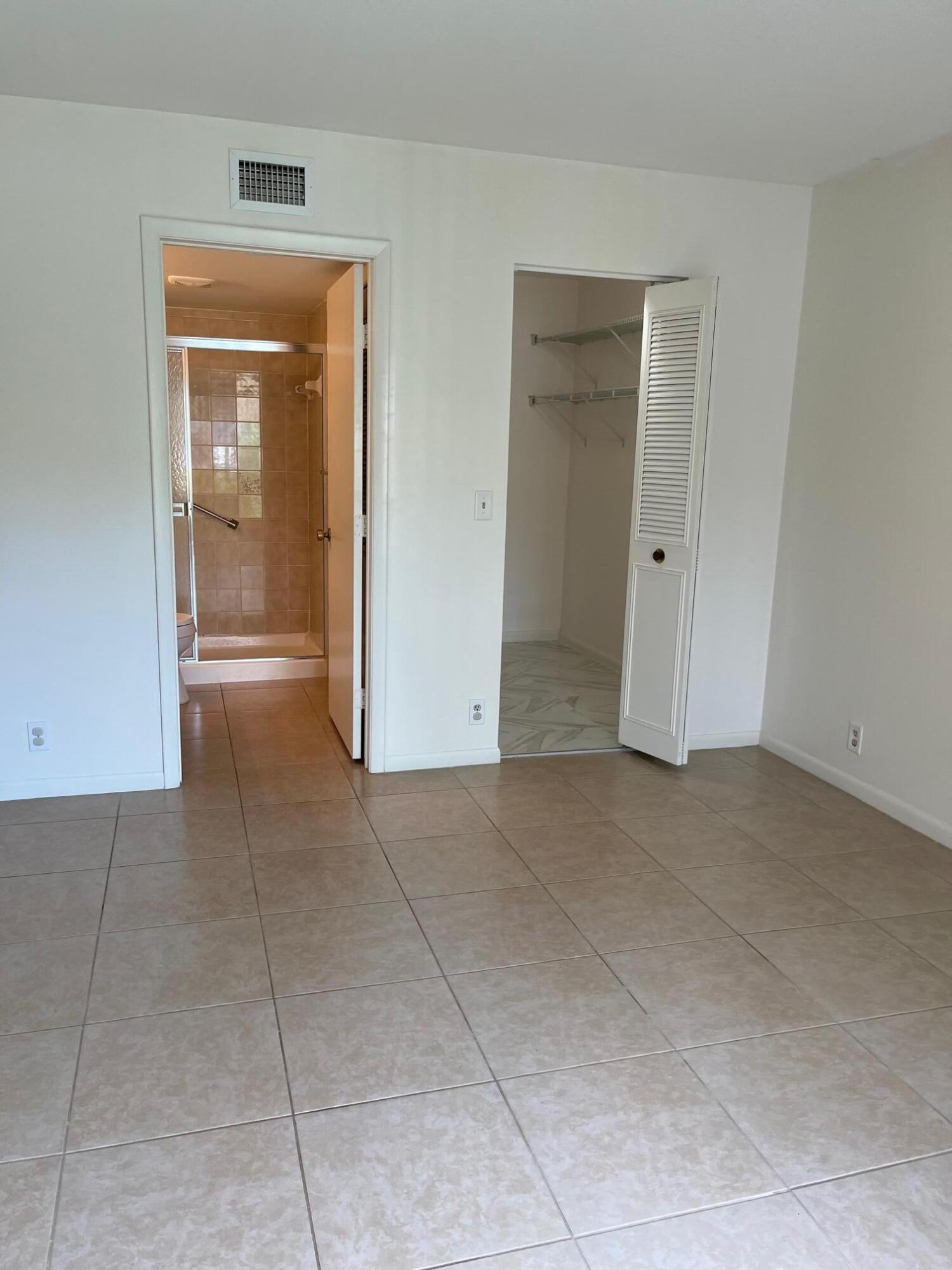 801 Sky Pine Way, Unit B1 Greenacres, FL 33415 - Photo 16 of 17 a view of an empty room with closet and a fireplace