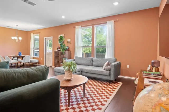 a living room with furniture and a floor to ceiling window