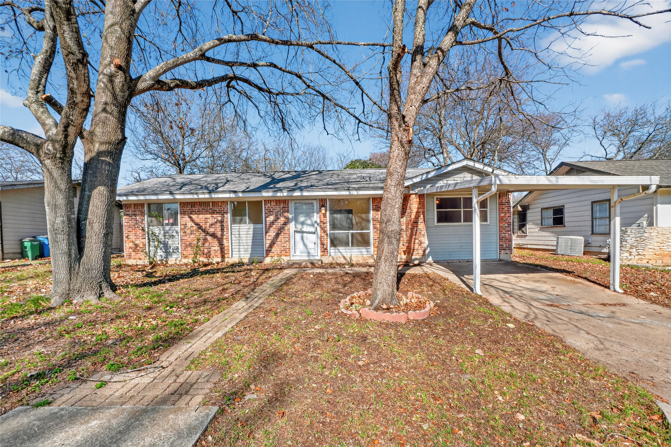 6502 Middleham Place Austin, TX 78745 - Photo 1 of 1 Ranch-style home with brick siding, concrete driveway, and an attached carport