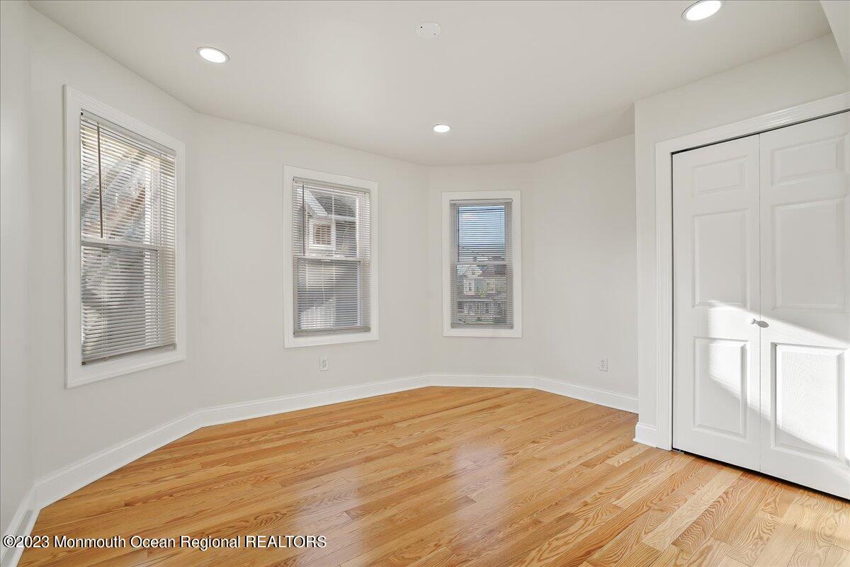 116 11th Avenue, Unit 2 Belmar, NJ 07719 - Photo 15 of 26 a view of empty room with wooden floor and fan