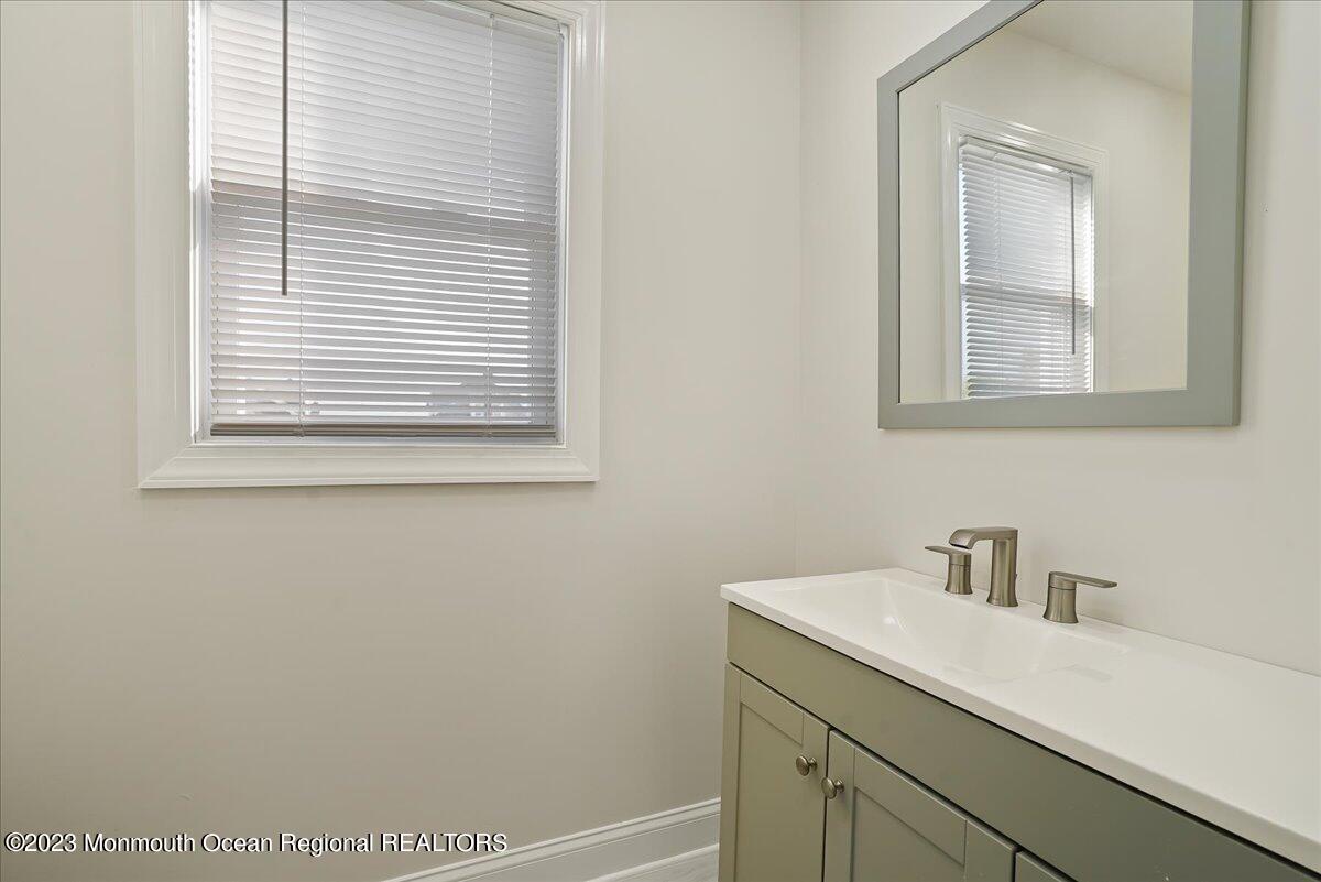116 11th Avenue, Unit 2 Belmar, NJ 07719 - Photo 18 of 26 a bathroom with a sink and a window