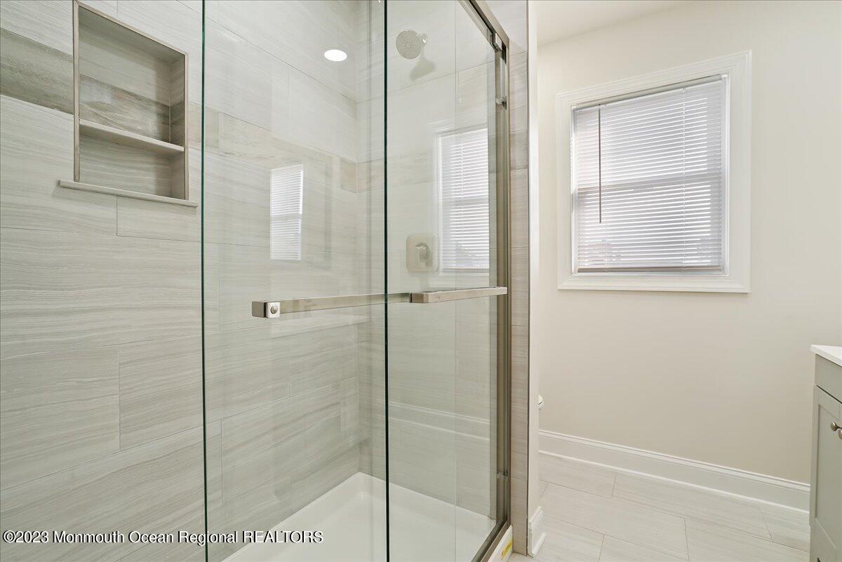 116 11th Avenue, Unit 2 Belmar, NJ 07719 - Photo 19 of 26 a bathroom with a shower and a glass door