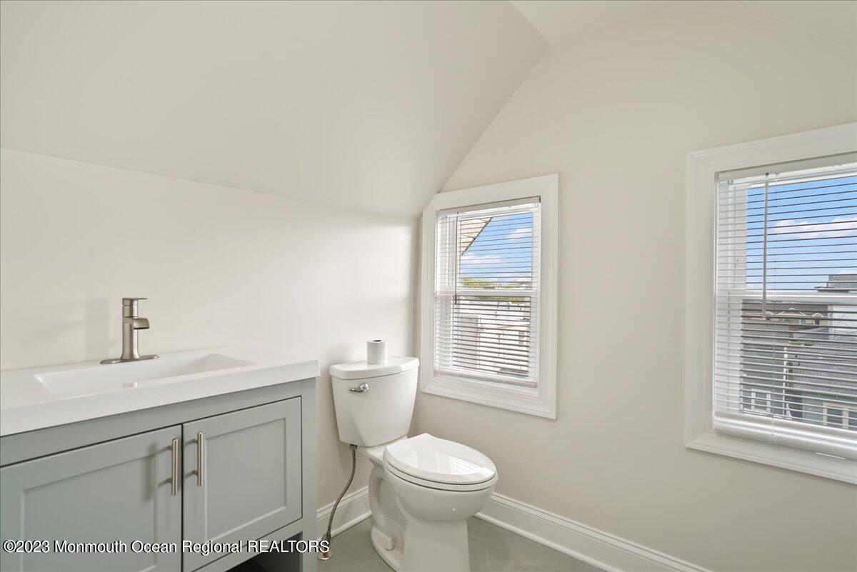 116 11th Avenue, Unit 2 Belmar, NJ 07719 - Photo 23 of 26 a white toilet sitting next to a bathroom sink