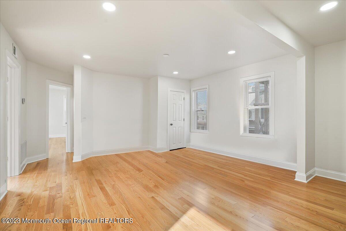 116 11th Avenue, Unit 2 Belmar, NJ 07719 - Photo 8 of 26 a big room with wooden floor and windows