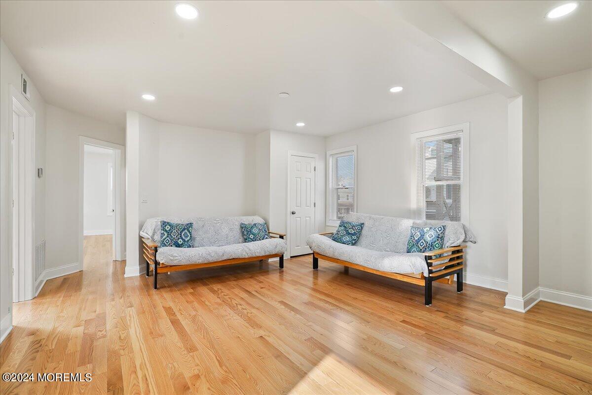 116 11th Avenue, Unit 2 Belmar, NJ 07719 - Photo 9 of 26 a living room with furniture and a wooden floor