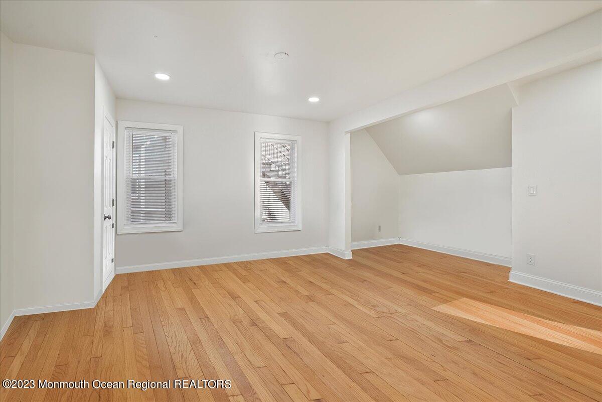116 11th Avenue, Unit 2 Belmar, NJ 07719 - Photo 10 of 26 a bedroom with a bed and a window