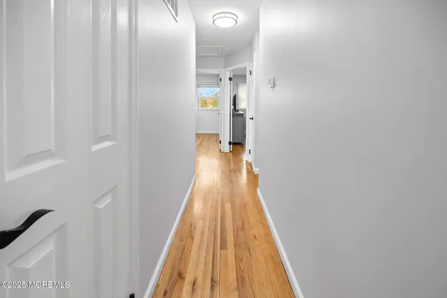 a bathroom with a sink a toilet a mirror and shower curtain