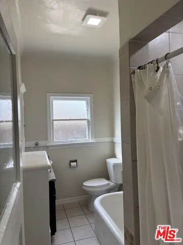a bathroom with a window and a shower