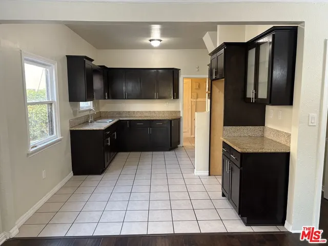 a kitchen with stainless steel appliances a sink and a refrigerator