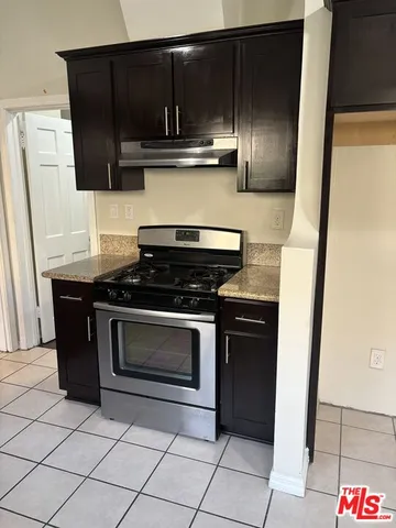 a kitchen with granite countertop cabinets and steel stainless steel appliances