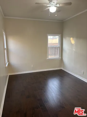 an empty room with wooden floor and door