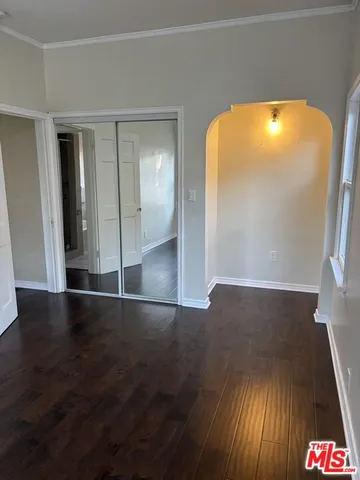 a bathroom with a granite countertop sink and a toilet