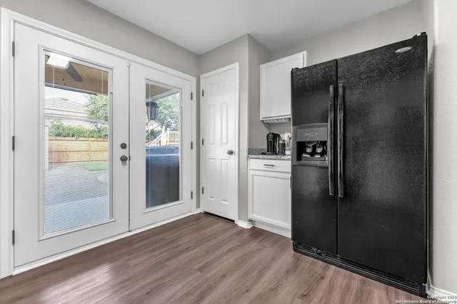 a kitchen with a refrigerator and a sink