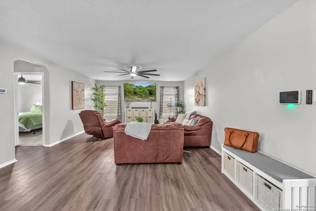 a living room with furniture and wooden floor