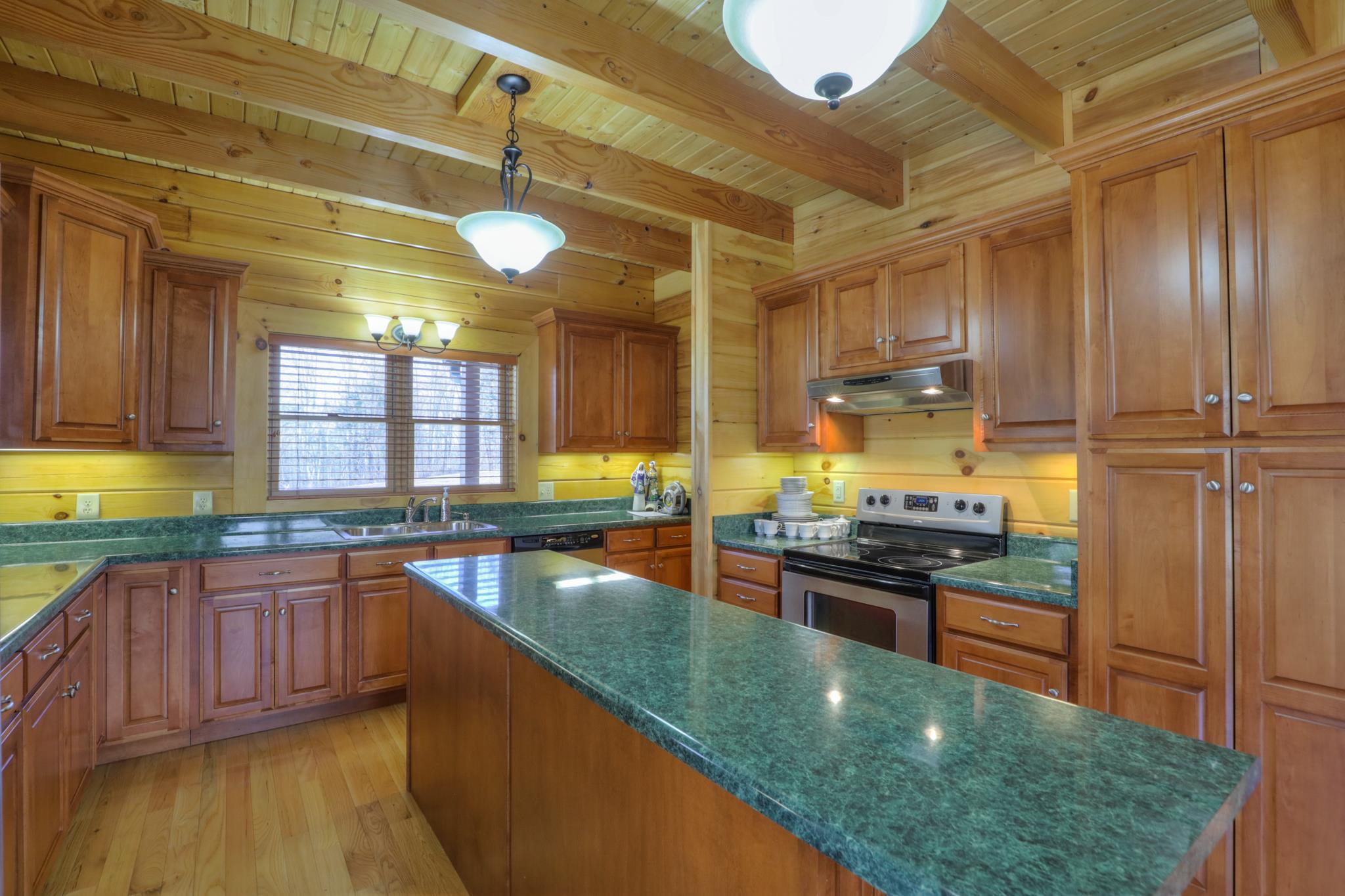 2267 Linwood Road Watertown, TN 37184 - Photo 12 of 30 a kitchen with stainless steel appliances granite countertop a stove a sink and a wooden cabinets
