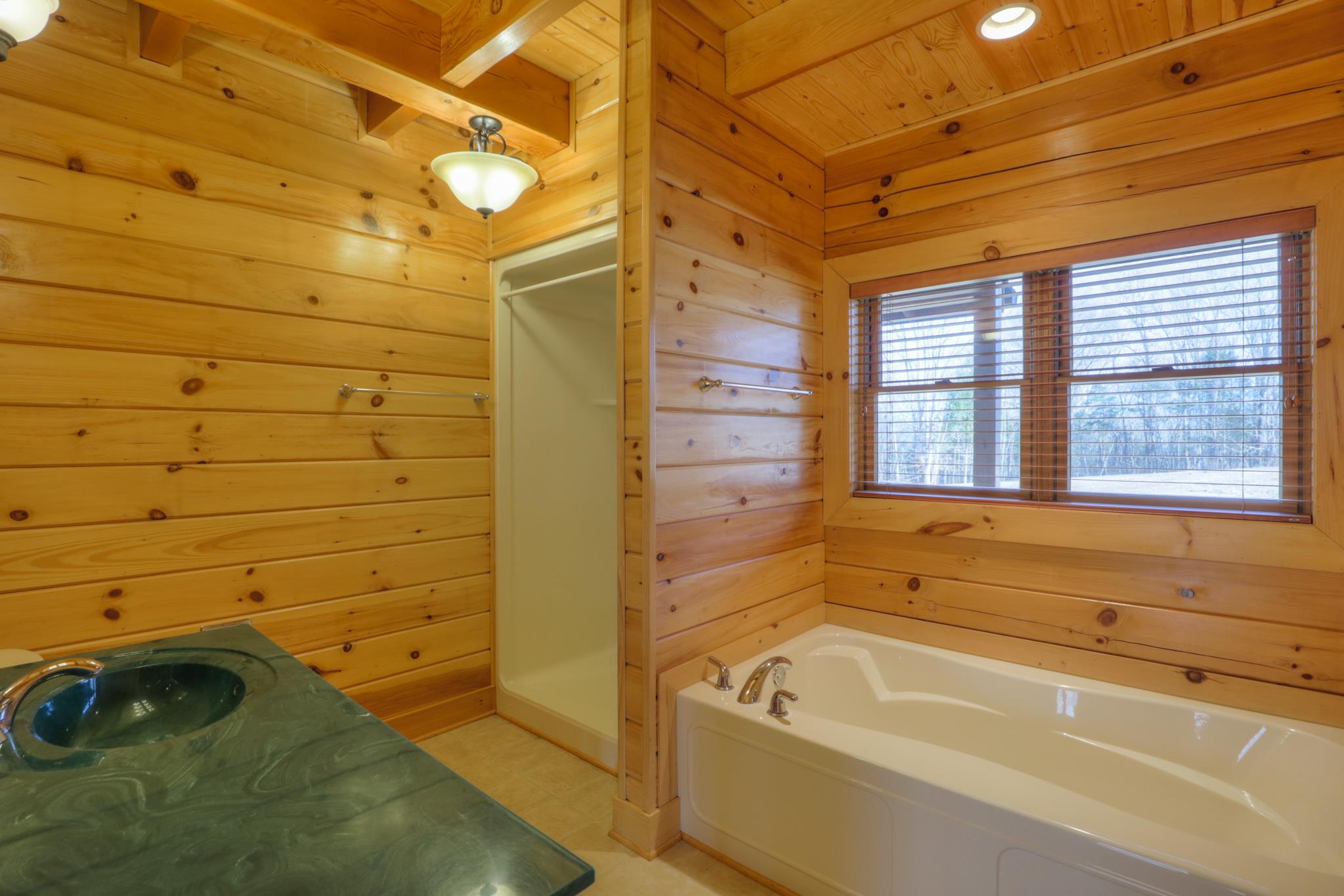 2267 Linwood Road Watertown, TN 37184 - Photo 17 of 30 a bathroom with a tub and a shower