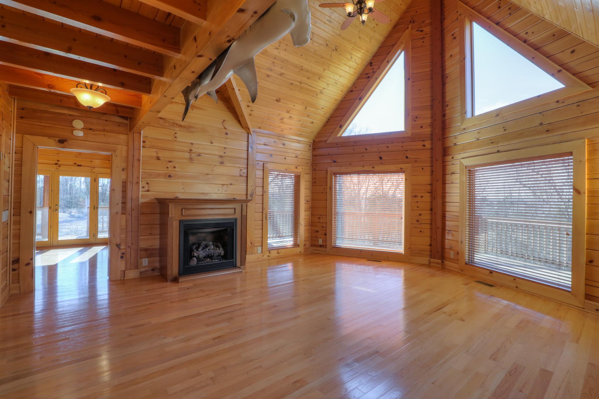 2267 Linwood Road Watertown, TN 37184 - Photo 10 of 30 a view of an empty room with wooden floor fireplace and a window