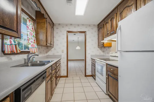a kitchen with a sink stove and cabinets