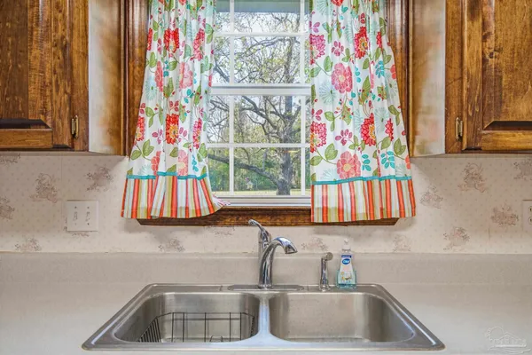 a bathroom with a sink and a curtain