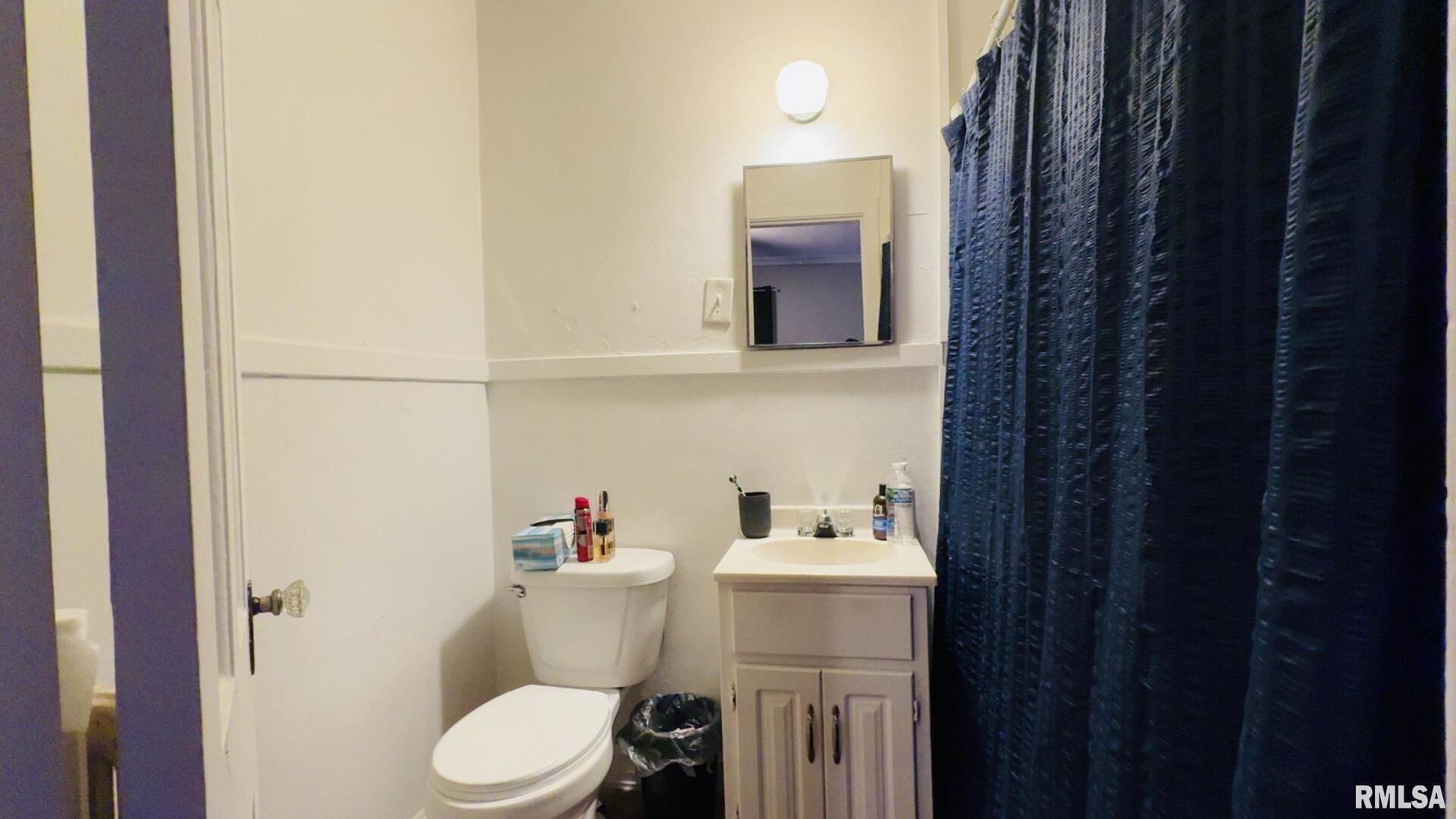 419 East Church Street Benton, IL 62812 - Photo 14 of 16 a bathroom with a sink a toilet and shower curtain