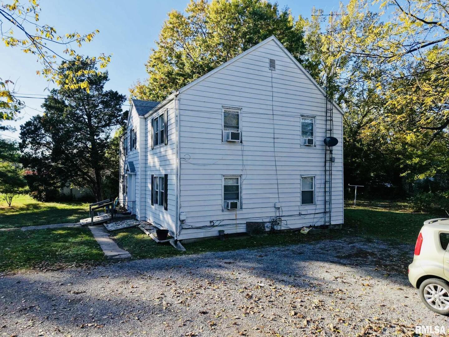 419 East Church Street Benton, IL 62812 - Photo 3 of 16 a view of a small house with a yard