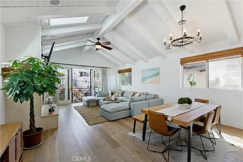 a living room with furniture a fireplace and a chandelier