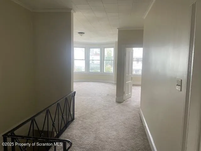 a view of hallway with windows