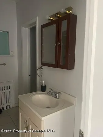 a bathroom with a sink and mirror