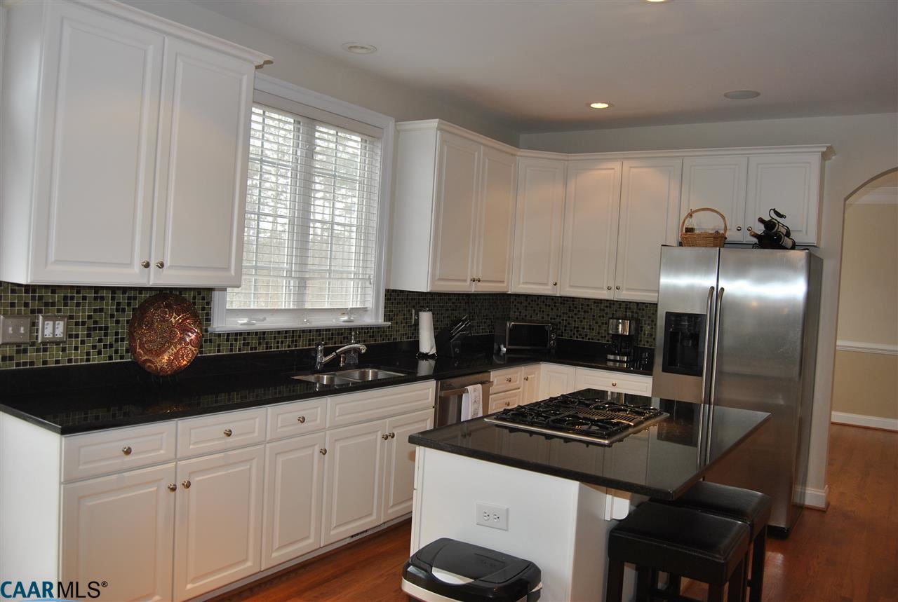 1860 Rhett Court Charlottesville, VA 22903 - Photo 14 of 39 a kitchen with granite countertop a stove a sink and a refrigerator